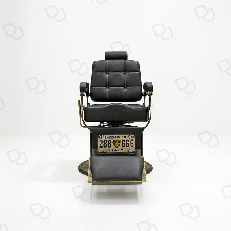 black vintage-style barber chair with quilted padded backrest, adjustable headrest, gold-tone details and footrest