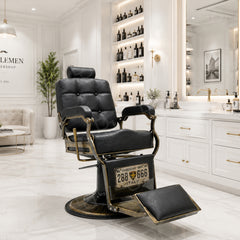 black vintage-style barber chair with quilted padded backrest, adjustable headrest, gold-tone details and footrest