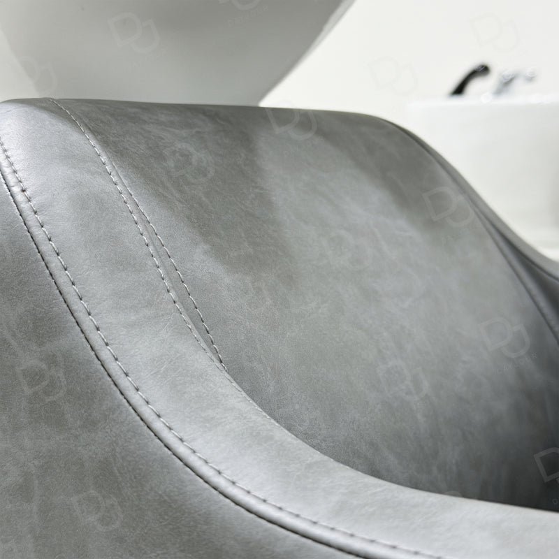 Professional grey salon hair washing chair with integrated white ceramic shampoo basin