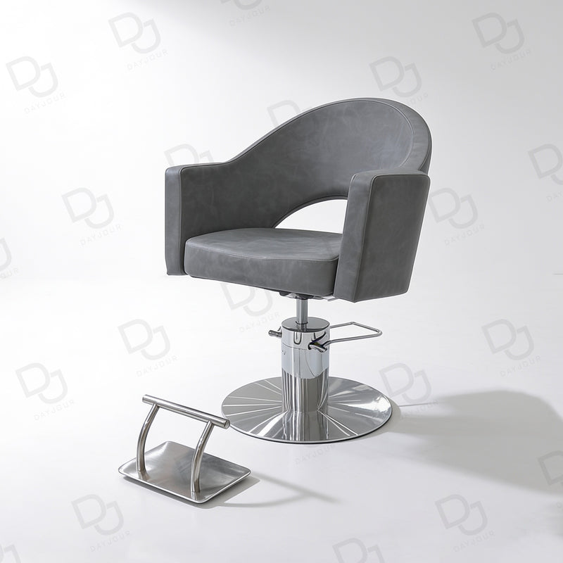 grey ladies styling chair with curved padded backrest, hydraulic chrome base and salon footrest