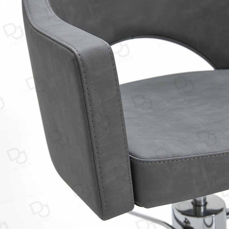 grey ladies styling chair with curved padded backrest, hydraulic chrome base and salon footrest