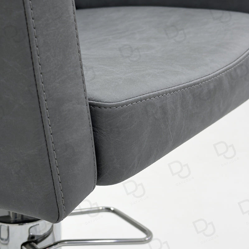 grey ladies styling chair with curved padded backrest, hydraulic chrome base and salon footrest
