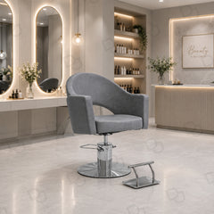 grey ladies styling chair with curved padded backrest, hydraulic chrome base and salon footrest